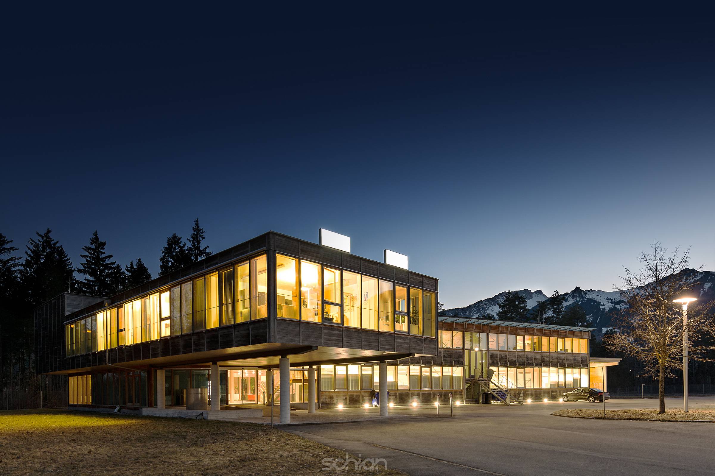 illuminated modern wooden office building at night