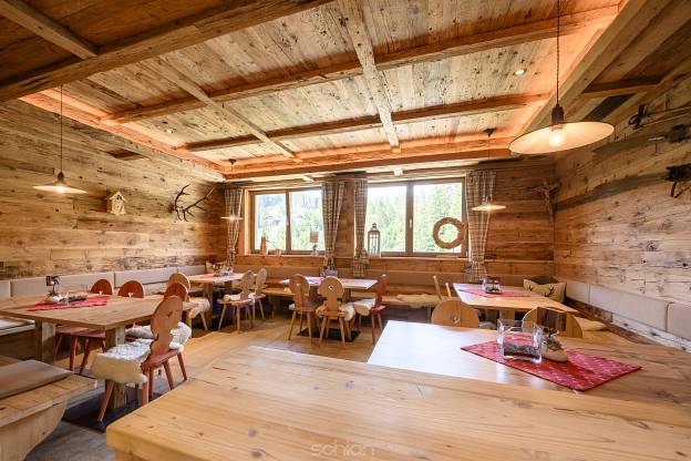 interior view of comfortable traditional rural wooden timber lounge with chairs and tables