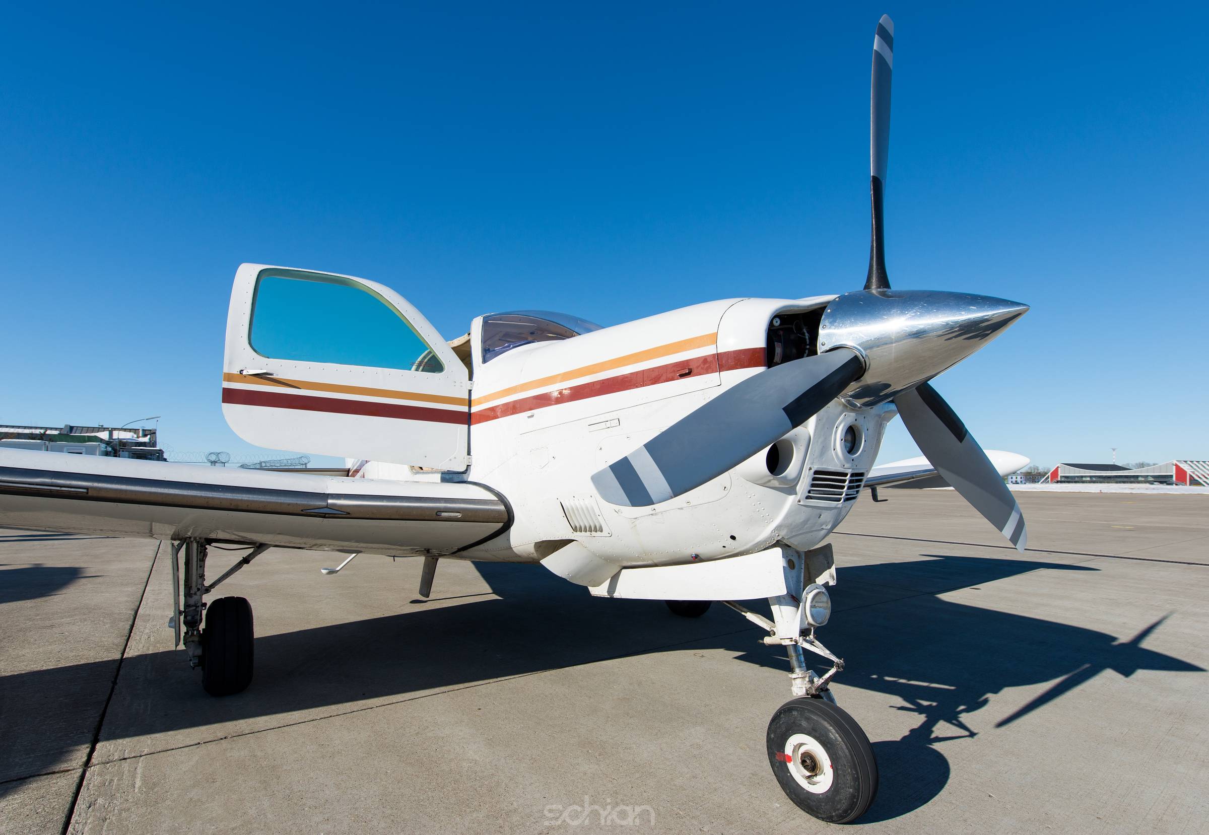 propeller aeroplane standing on asphalt landing runway